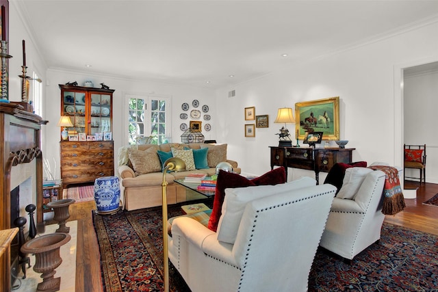 living room featuring wood-type flooring and ornamental molding