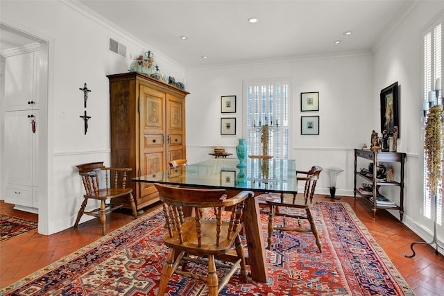 dining area featuring crown molding and a wealth of natural light