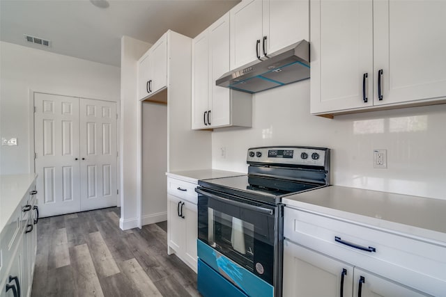 kitchen with white cabinetry, stainless steel electric range oven, and light hardwood / wood-style flooring