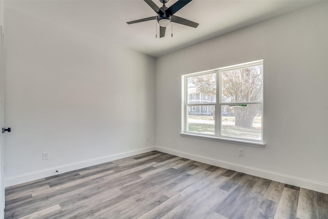 spare room with ceiling fan and light hardwood / wood-style floors