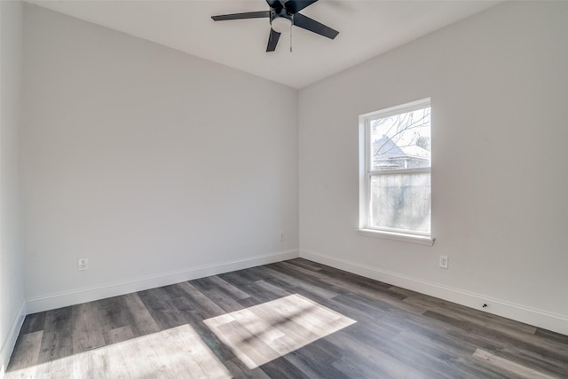 empty room with ceiling fan and dark hardwood / wood-style flooring