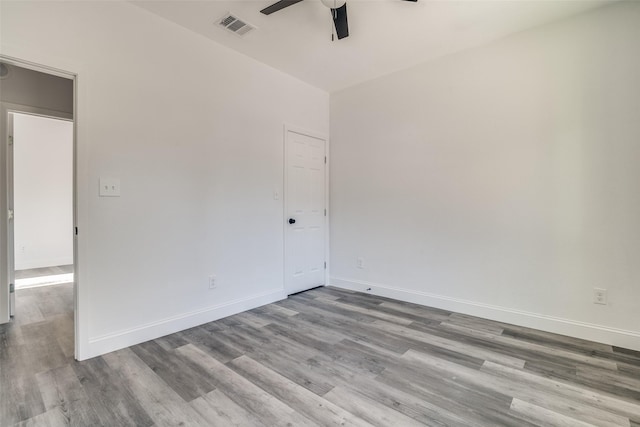 spare room with ceiling fan and light wood-type flooring