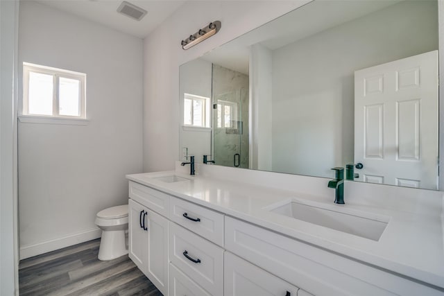 bathroom featuring hardwood / wood-style floors, vanity, toilet, and a healthy amount of sunlight