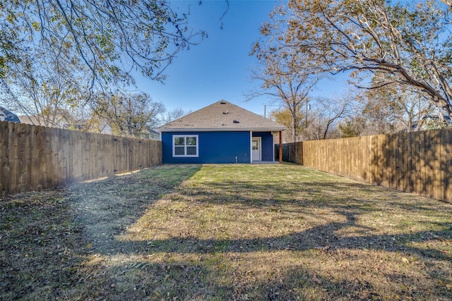 back of house featuring a yard