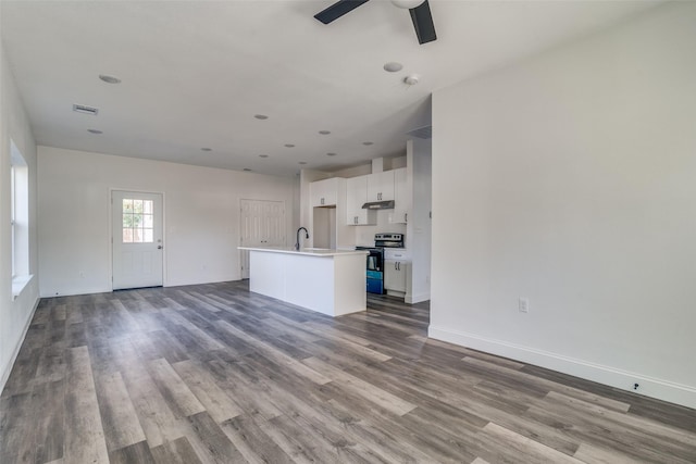 unfurnished living room featuring ceiling fan, light wood-type flooring, and sink