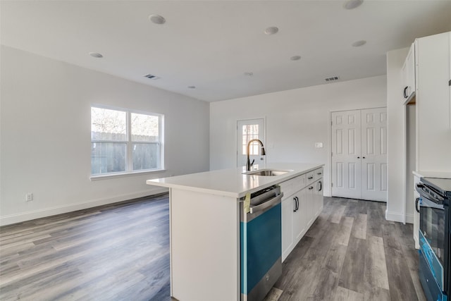 kitchen featuring stainless steel dishwasher, sink, white cabinets, black electric range oven, and an island with sink