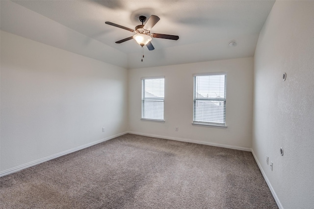 carpeted empty room with ceiling fan and lofted ceiling