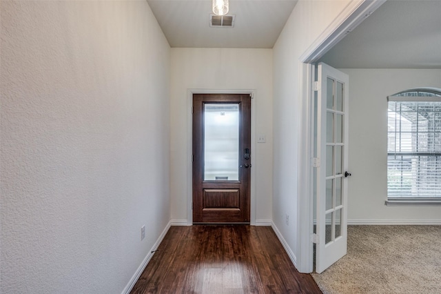 doorway with dark hardwood / wood-style flooring and french doors