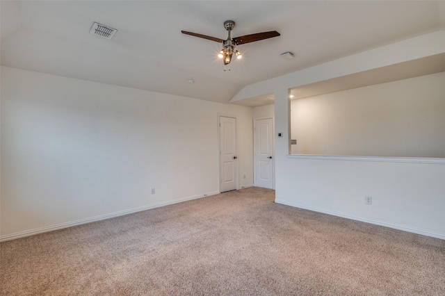 empty room with carpet, vaulted ceiling, and ceiling fan