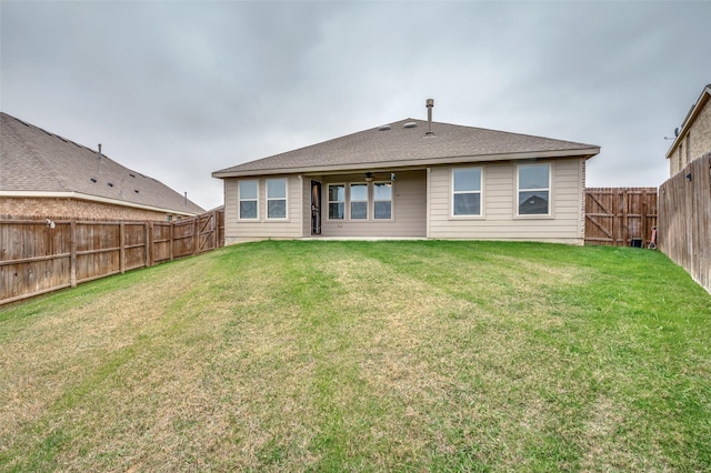 rear view of property with a yard