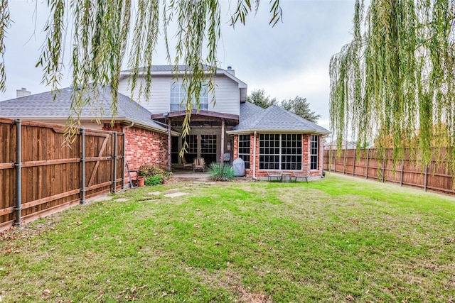 rear view of house with a yard