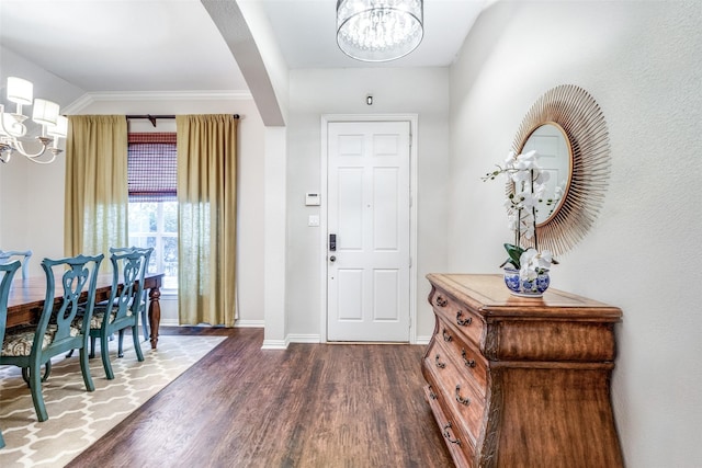 entryway featuring dark wood-type flooring and a notable chandelier