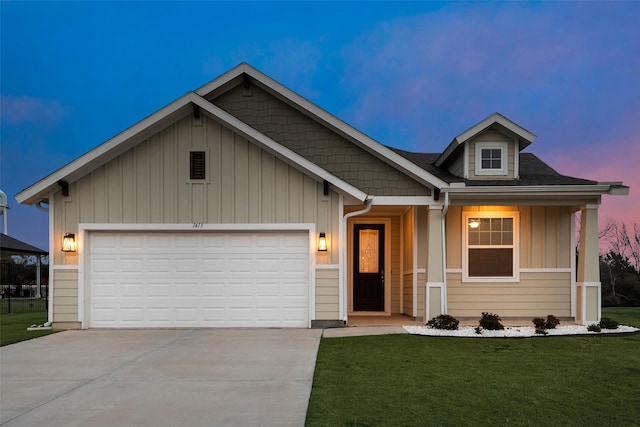 view of front of home featuring a lawn and a garage