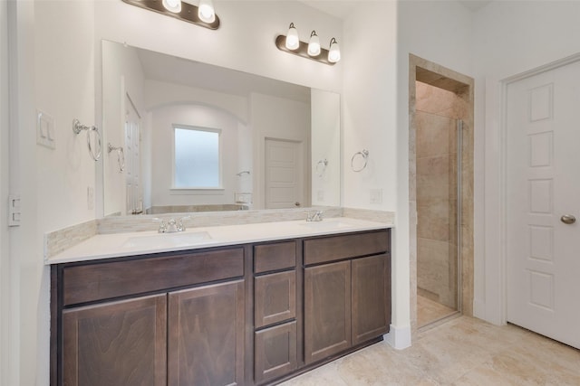 bathroom featuring vanity and tiled shower