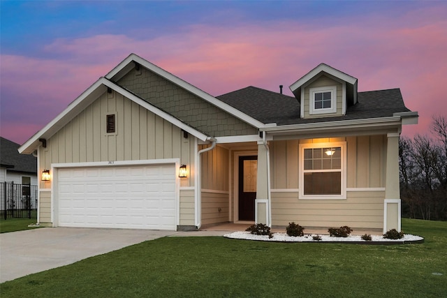 view of front of house featuring a garage and a yard