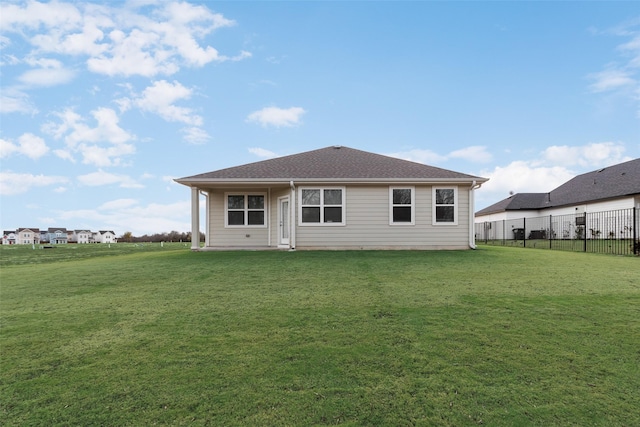 rear view of house with a lawn