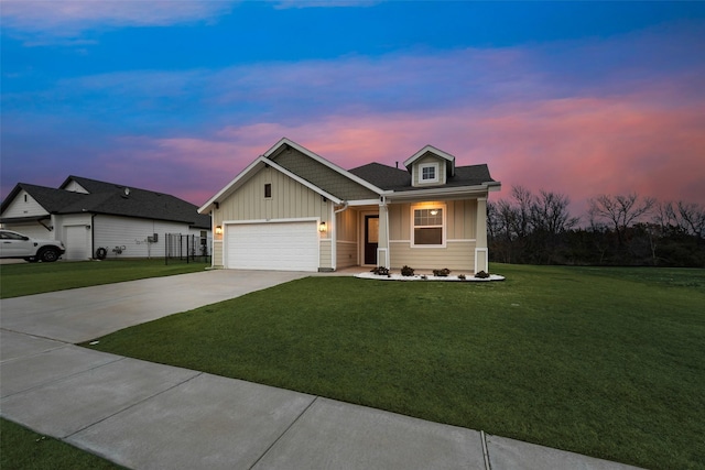 view of front facade featuring a garage and a lawn