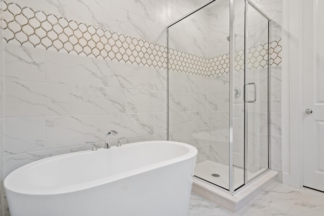 bathroom with tile walls and independent shower and bath