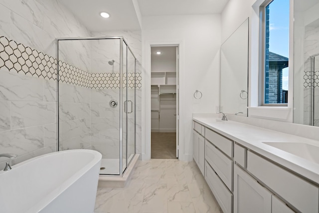 bathroom featuring vanity and independent shower and bath