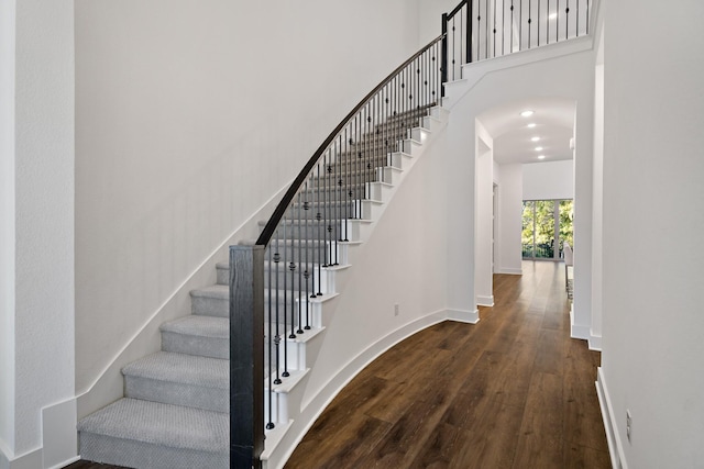 stairway with hardwood / wood-style floors