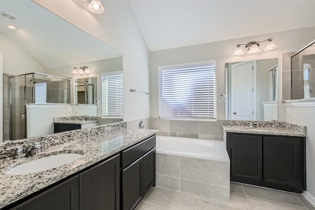 bathroom featuring tile patterned flooring, vanity, separate shower and tub, and lofted ceiling