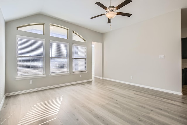 spare room with light hardwood / wood-style flooring, ceiling fan, and lofted ceiling