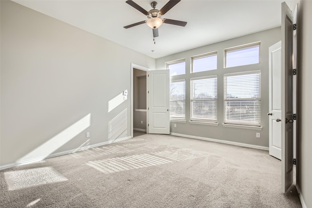 unfurnished bedroom featuring ceiling fan and light carpet