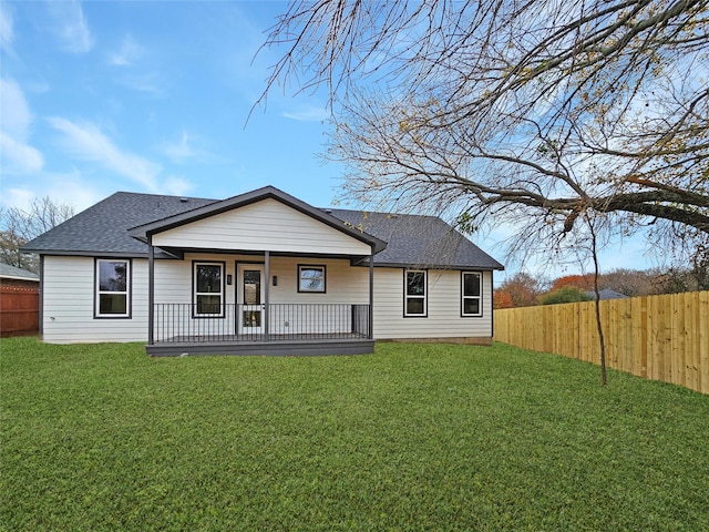 back of property with a porch and a yard