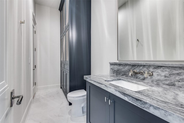 bathroom featuring decorative backsplash, vanity, and toilet