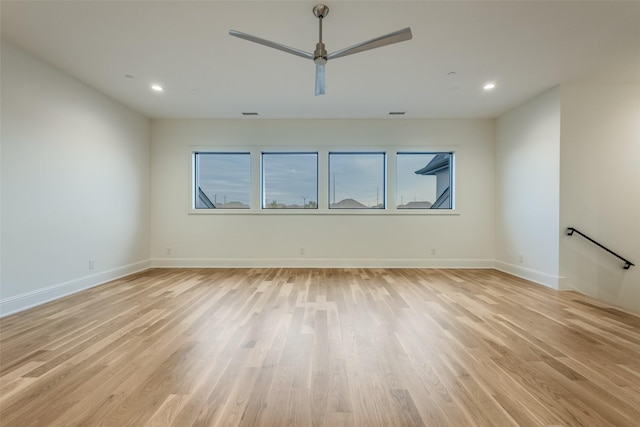 empty room with light hardwood / wood-style flooring and ceiling fan