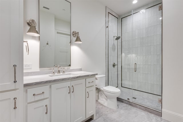 bathroom with vanity, an enclosed shower, and toilet