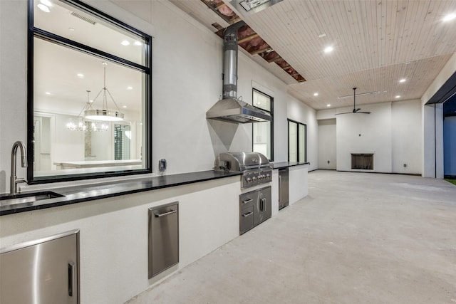 kitchen featuring pendant lighting, refrigerator, a fireplace, sink, and wooden ceiling