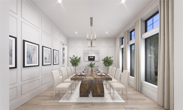 dining area with crown molding, plenty of natural light, and light hardwood / wood-style floors