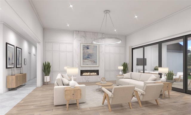 living room featuring crown molding, light hardwood / wood-style flooring, and a large fireplace