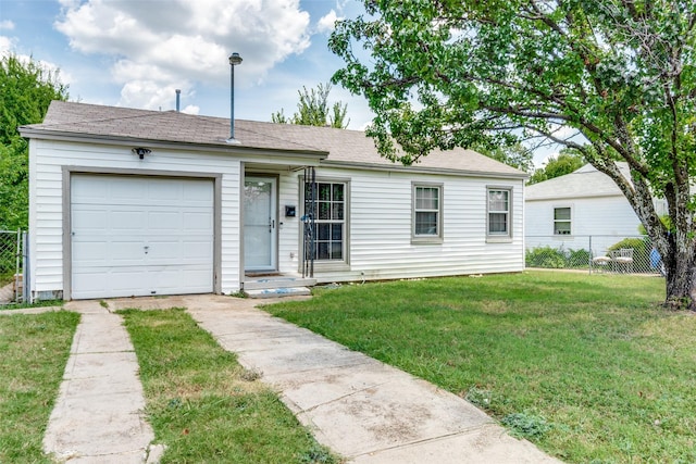 ranch-style house with a garage and a front lawn