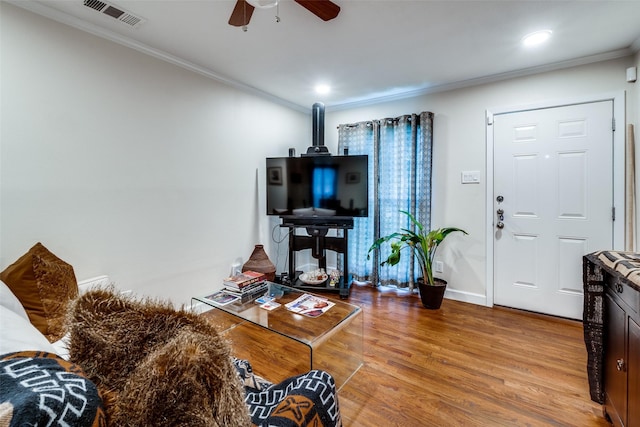 living room with ceiling fan, light hardwood / wood-style floors, and crown molding