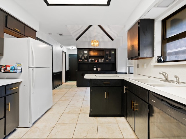 kitchen with sink, dishwasher, white refrigerator, kitchen peninsula, and pendant lighting