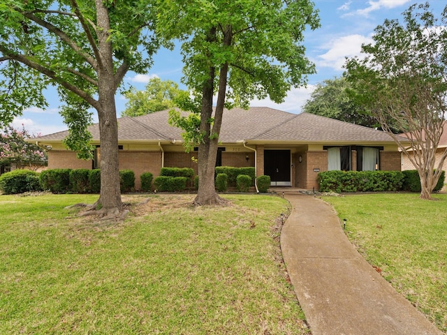 ranch-style home with a front lawn