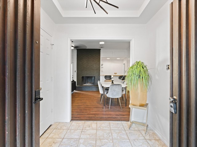 tiled entryway with a brick fireplace