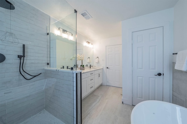 bathroom featuring plus walk in shower, vanity, and tile walls