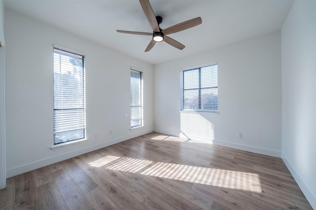 spare room featuring ceiling fan and light hardwood / wood-style floors