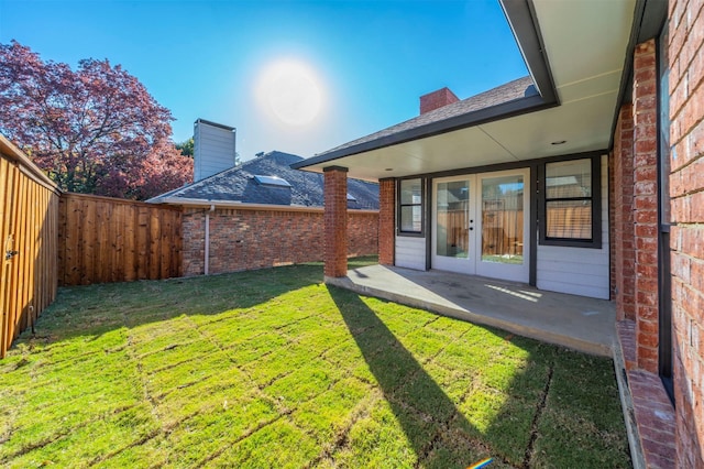 view of yard featuring french doors and a patio