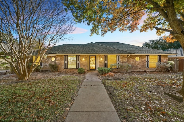 ranch-style house with a lawn