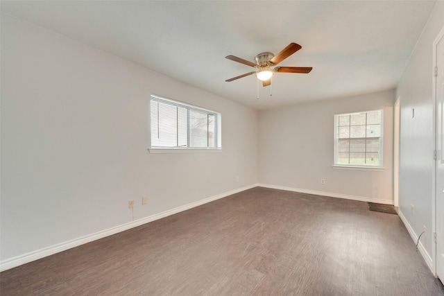 unfurnished room with ceiling fan and dark hardwood / wood-style flooring