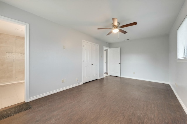 spare room featuring ceiling fan and dark hardwood / wood-style flooring