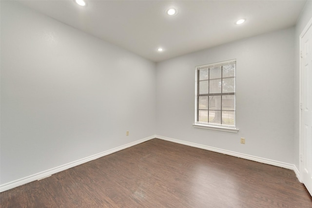 unfurnished room with dark hardwood / wood-style floors