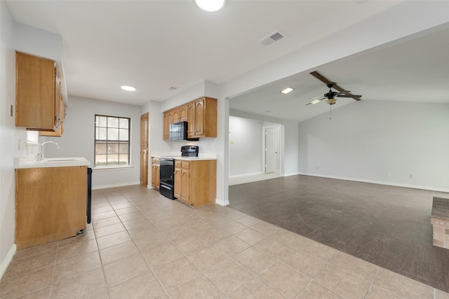 kitchen with light colored carpet, vaulted ceiling, ceiling fan, sink, and black appliances