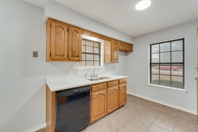 kitchen featuring sink, light tile patterned flooring, and black dishwasher