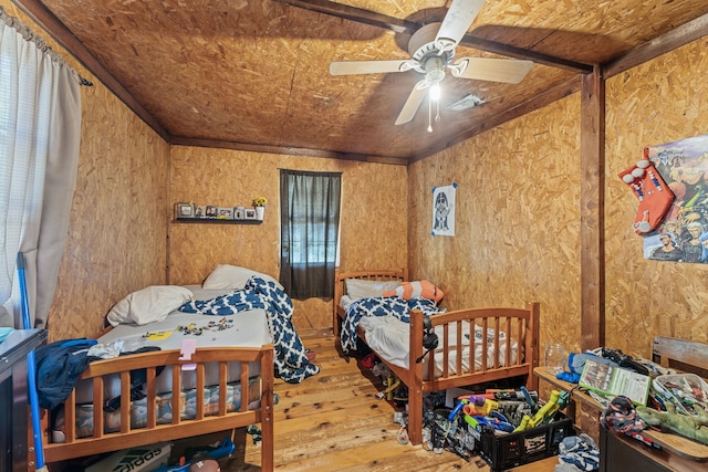 bedroom featuring multiple windows, hardwood / wood-style floors, ceiling fan, and lofted ceiling