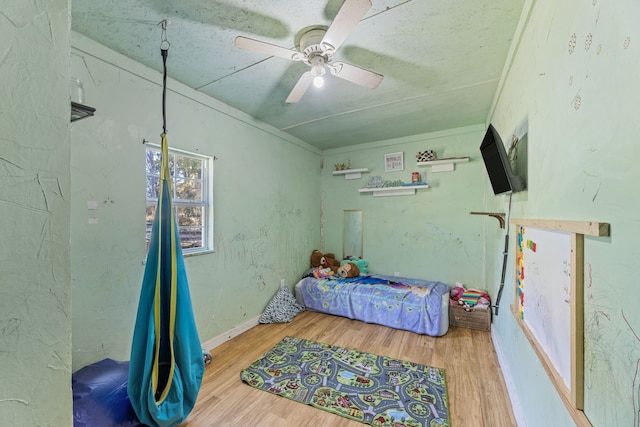 bedroom with ceiling fan and wood-type flooring